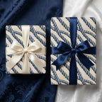 Nautical navy blue rope wrapping paper with satin bows on gift boxes by Wrapped Studios.