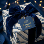 Luxury nautical wrapping paper with navy rope pattern and blue velvet bow by Wrapped Studios.