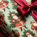 Vintage Santa Christmas wrapping paper in sage green with a burgundy ribbon by Wrapped Studios.