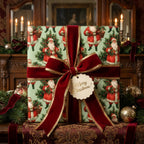 Vintage Santa Christmas wrapping paper on a luxury gift with a red velvet bow by Wrapped Studios.