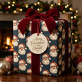 Vintage Santa Christmas wrapping paper in navy blue with a red velvet bow by Wrapped Studios.