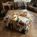 Vintage Santa Christmas wrapping paper with a gold satin bow, by Wrapped Studios.