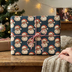 Vintage Santa Christmas gift wrap in navy blue, tied with red and white twine by Wrapped Studios.