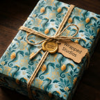 Teal and gold coastal seahorse wrapping paper by Wrapped Studios, tied with a rustic twine bow and wax seal.