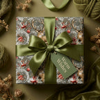 Vintage deer Christmas wrapping paper with olive green satin bow and rustic holiday tag by Wrapped Studios.