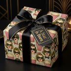 Vintage Hollywood wrapping paper by Wrapped Studios with retro film pattern and elegant black bow.