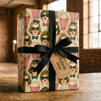 Retro movie wrapping paper with vintage print, black bow, and Admit One gift tag by Wrapped Studios.