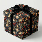 Elegant gift wrapped in bird and strawberry patterned wrapping paper with a black velvet ribbon.