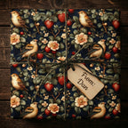 Square gift wrapped in bird, strawberry and flower print wrapping paper with twine bow.