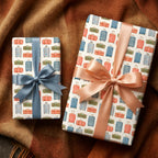 Vintage travel wrapping paper with a retro suitcase pattern and satin ribbons by Wrapped Studios.