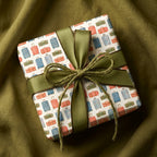 Vintage suitcase travel wrapping paper with an olive green ribbon by Wrapped Studios.