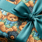 Cute teddy bear wrapping paper with a teal satin bow, perfect baby shower gift wrap by Wrapped Studios.