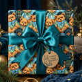 Teddy bear birthday wrapping paper with a large teal satin bow and gift tag by Wrapped Studios.