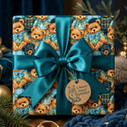 Teddy bear birthday wrapping paper with a large teal satin bow and gift tag by Wrapped Studios.