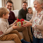 Grandmother giving boy a gift in teddy bear birthday wrapping paper with a red bow, by Wrapped Studios.