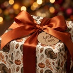 Rustic Thanksgiving wrapping paper with turkeys and pumpkins and a copper satin bow by Wrapped Studios.
