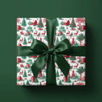Vintage Christmas toile wrapping paper with a dark green satin bow on a gift box, by Wrapped Studios.