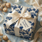 Vintage blue toile wrapping paper with a cream satin bow on a luxury gift box by Wrapped Studios.