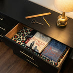 Retro vinyl record wrapping paper used as a dresser drawer liner with vintage tees, by Wrapped Studios.