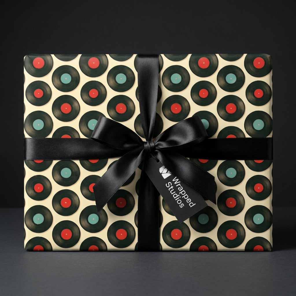 Retro vinyl record wrapping paper by Wrapped Studios, with a black satin bow on a music themed gift.