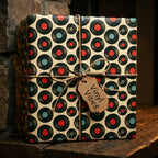 Retro vinyl record wrapping paper with twine bow on a gift box, music gift wrap by Wrapped Studios.