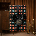 Retro vinyl record wrapping paper with a black satin bow by Wrapped Studios.
