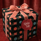Retro vinyl record wrapping paper with pink velvet ribbon and Spin Me tag by Wrapped Studios.