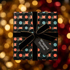 Retro vinyl record wrapping paper with black velvet ribbon on a gift box, by Wrapped Studios.