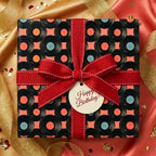 Retro vinyl record birthday wrapping paper with red ribbon and Happy Birthday tag by Wrapped Studios.