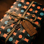 Music themed retro vinyl record wrapping paper with twine bow by Wrapped Studios.