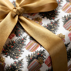 Elegant Christmas tree wrapping paper tied with a luxury gold satin bow by Wrapped Studios.