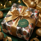 Luxury Christmas wrapping paper with festive tree print and gold satin bow by Wrapped Studios.