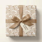 Vintage floral wrapping paper in neutral beige with a satin ribbon bow by Wrapped Studios.