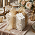 Luxury wedding wrapping paper in a vintage beige floral pattern with a gold bow by Wrapped Studios.