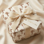 Rustic farmhouse wrapping paper with windmill print, cream velvet bow, and gift tag by Wrapped Studios.