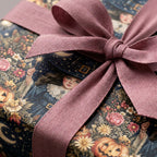 Vintage witch wrapping paper with a pink fabric bow on a Halloween gift from Wrapped Studios.