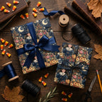 Vintage witch Halloween wrapping paper by Wrapped Studios, styled on gifts with navy blue ribbon.