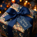 Vintage Halloween wrapping paper with pumpkins, navy bow, and gift tag by Wrapped Studios.