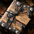 Vintage Halloween wrapping paper featuring witches and pumpkins, tied with twine by Wrapped Studios.