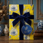 Yellow floral wrapping paper with a luxury navy velvet ribbon and gift tag by Wrapped Studios.