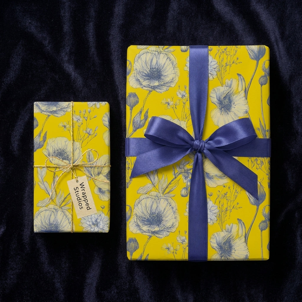 Yellow floral wrapping paper with blue botanical sketch pattern and satin ribbon, by Wrapped Studios.