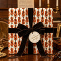 Vintage violin wrapping paper with a luxury velvet bow by Wrapped Studios.