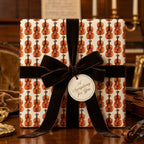 Vintage violin wrapping paper with a luxury velvet bow by Wrapped Studios.