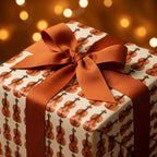 Violin wrapping paper with a brown ribbon bow on a gift box by Wrapped Studios.