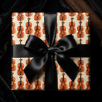 Luxury violin wrapping paper with a black satin bow on a gift box by Wrapped Studios.