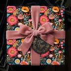 Elegant floral wrapping paper on square gift box with pink velvet ribbon and "For You" tag.