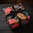 Elegant gift wrapped in floral wrapping paper with a black velvet bow.