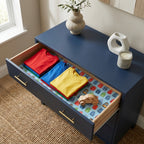 Kids backpack wrapping paper used as a drawer liner in a blue dresser by Wrapped Studios.
