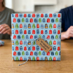 Back to school wrapping paper with a colorful backpack pattern and gift tag by Wrapped Studios.