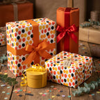 Autumn balloon birthday wrapping paper on gifts with orange and red ribbons by Wrapped Studios.